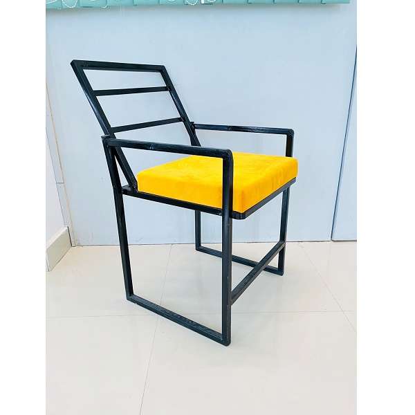 black iron chair with yellow cushion