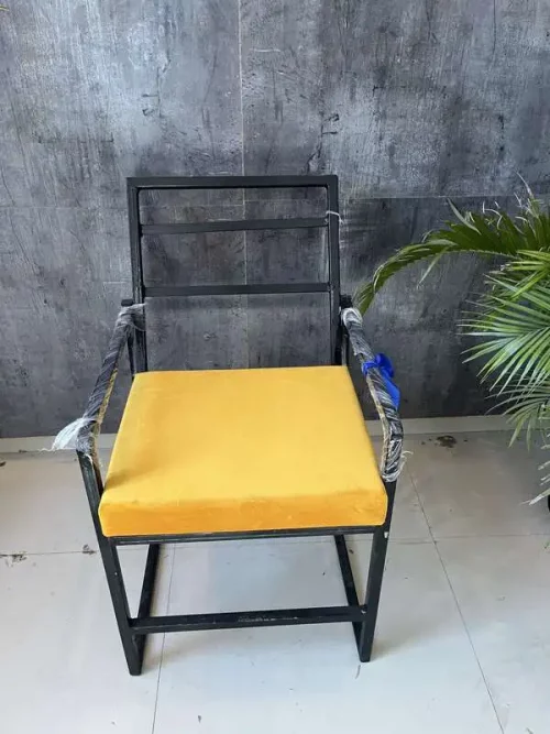 handmade black iron chair with yellow cushion for home decor
